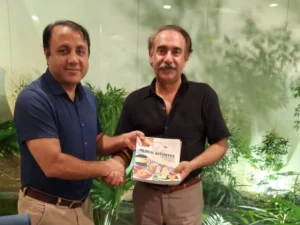 Dr Mohsin Presenting Medical Aesthetic Books to Senior Doctor